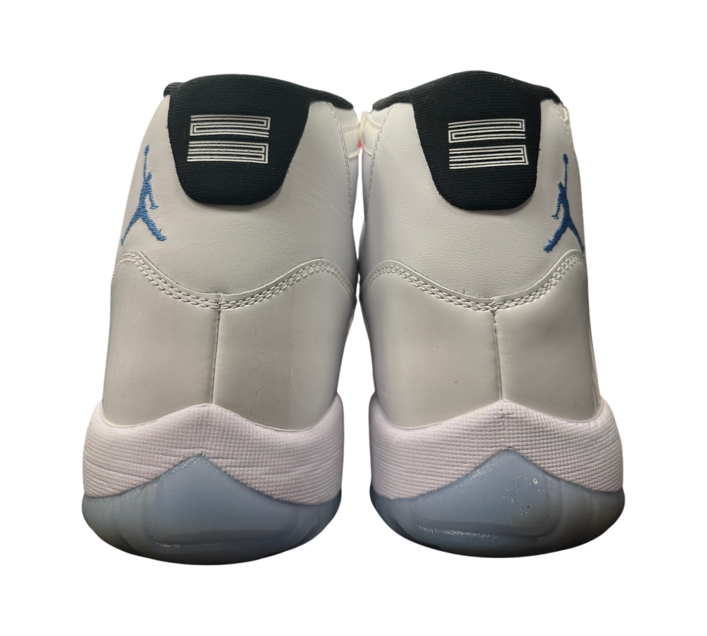 Genesis Boutique Jordan 11 Legend Blue sneakers showing the white leather heels and blue Jumpman logos