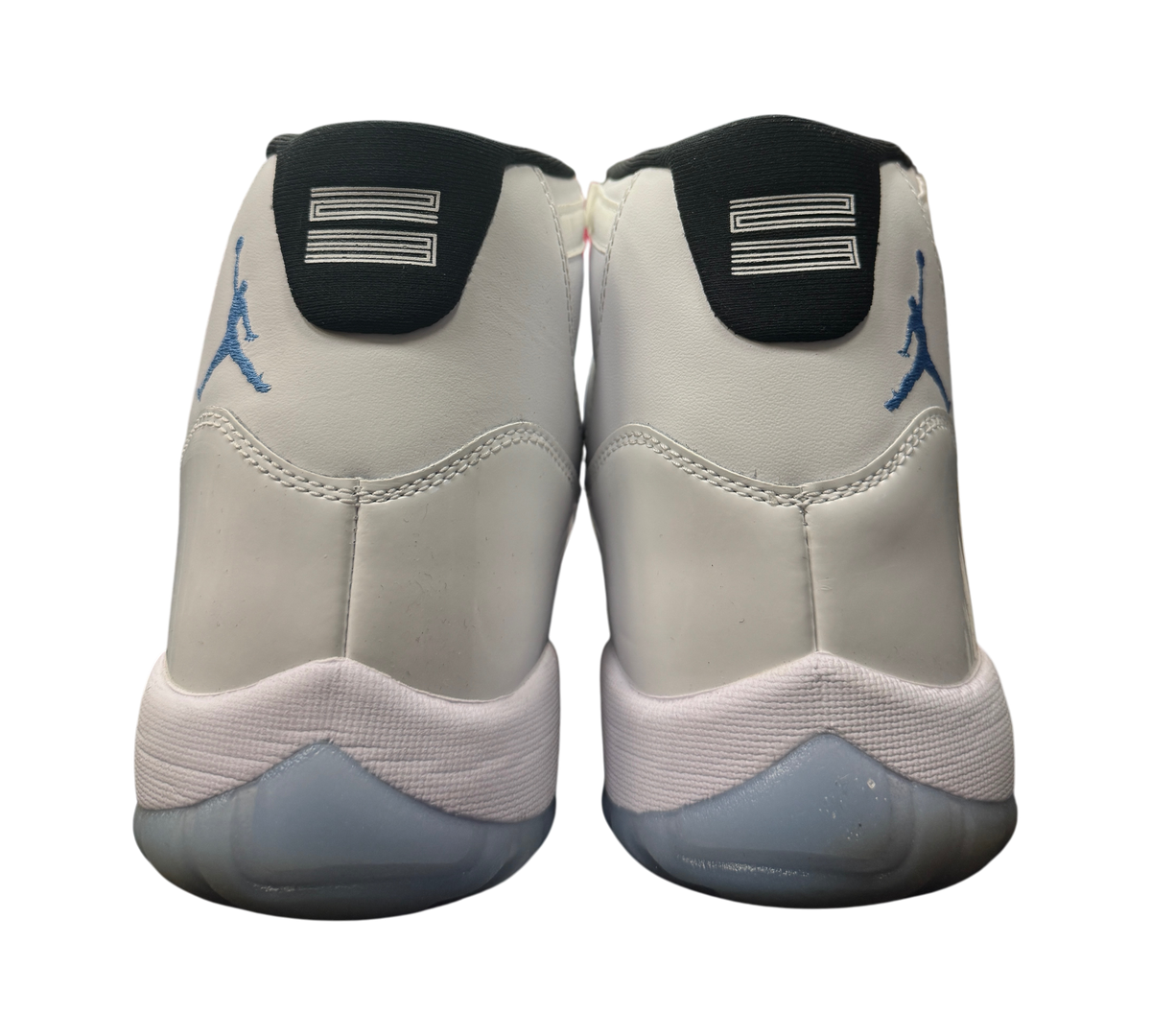 Genesis Boutique Jordan 11 Legend Blue sneakers showing the white leather heels and blue Jumpman logos