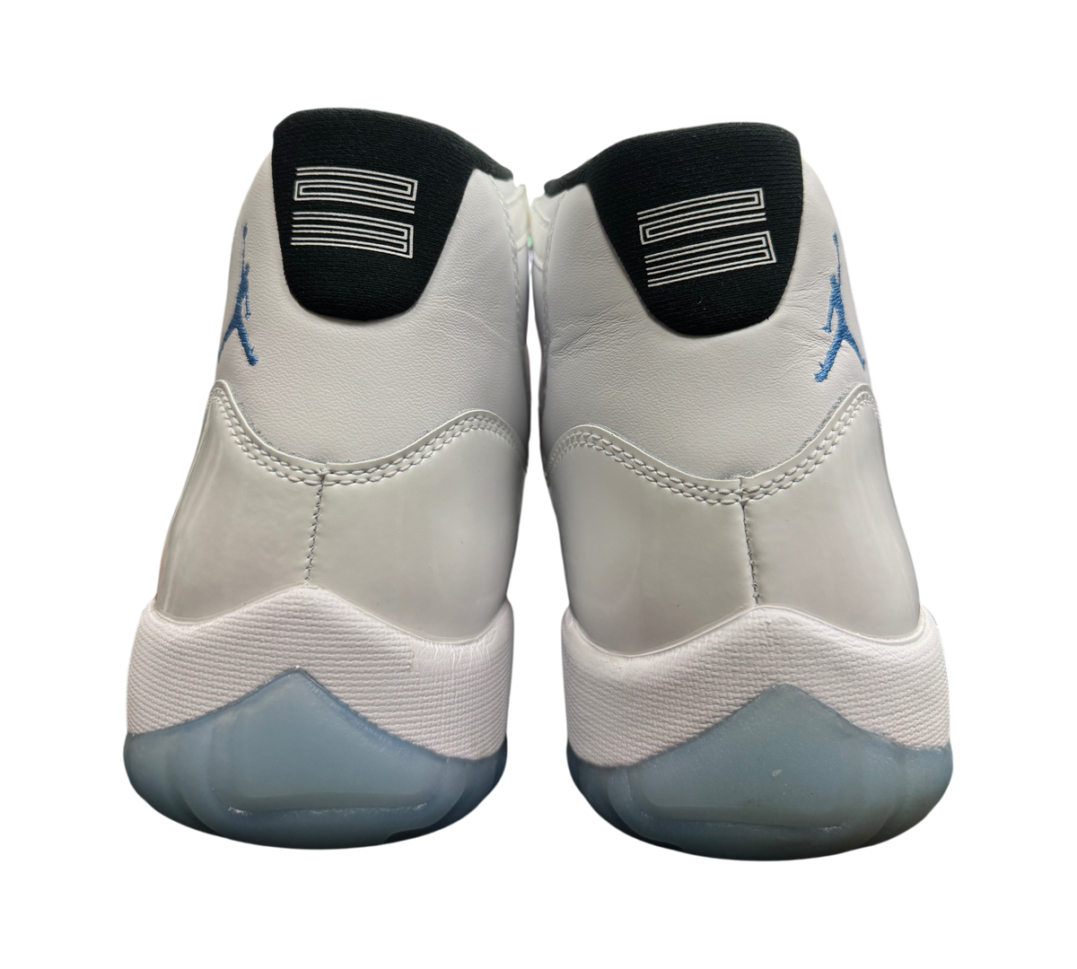 Genesis Boutique Jordan 11 Legend Blue sneakers showing white leather heels with blue Jumpman logo and 23 branding