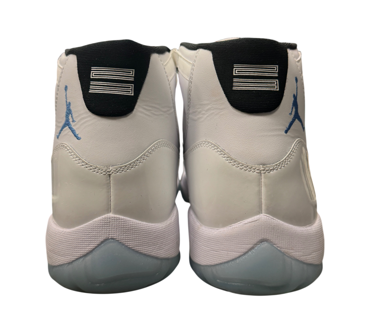 Genesis Boutique Jordan 11 Legend Blue sneakers showing the white leather heels with blue Jumpman logos and 23 branding