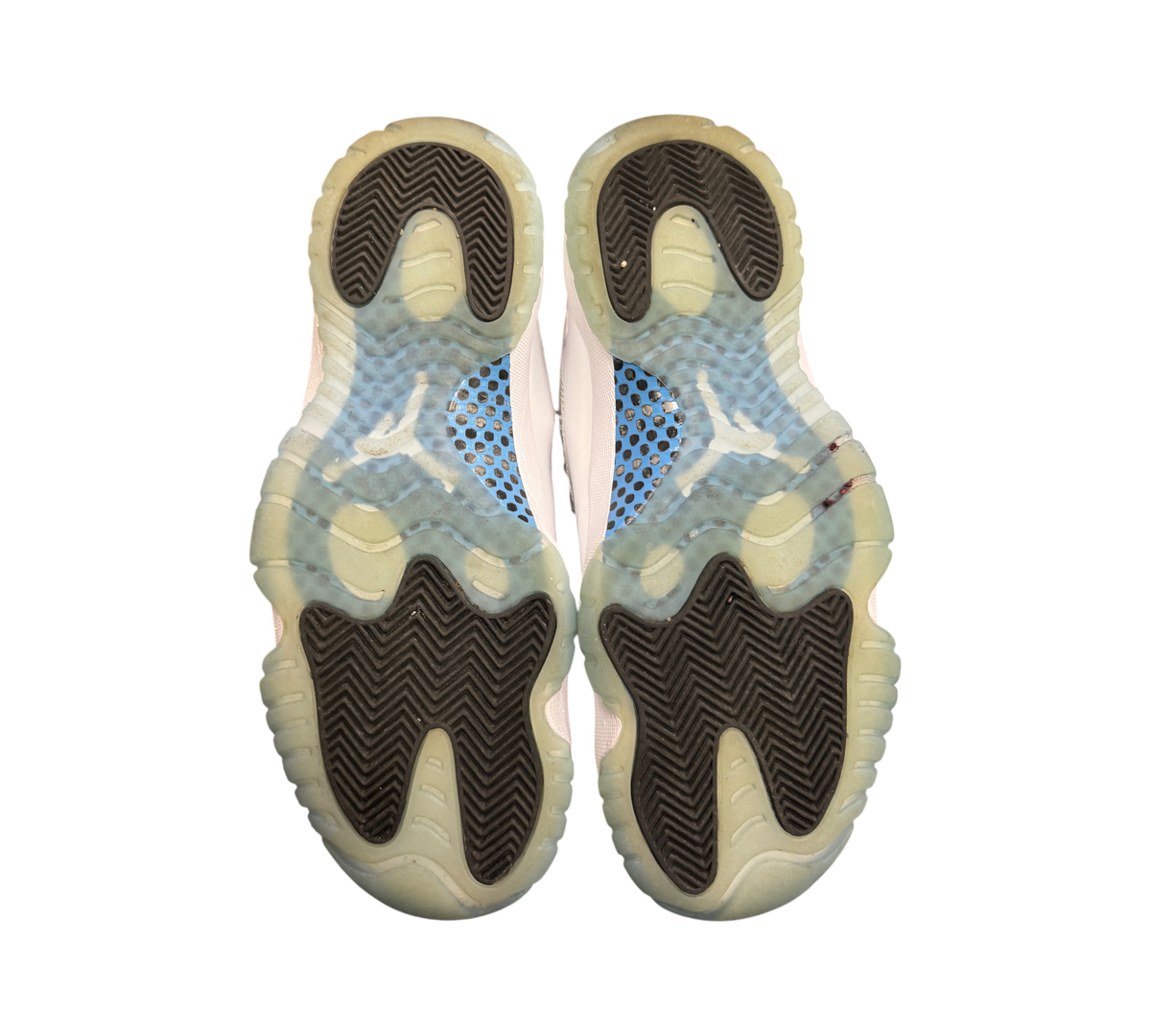 Genesis Boutique used Jordan 11 Legend Blue sneakers showing the translucent icy blue and black rubber outsoles