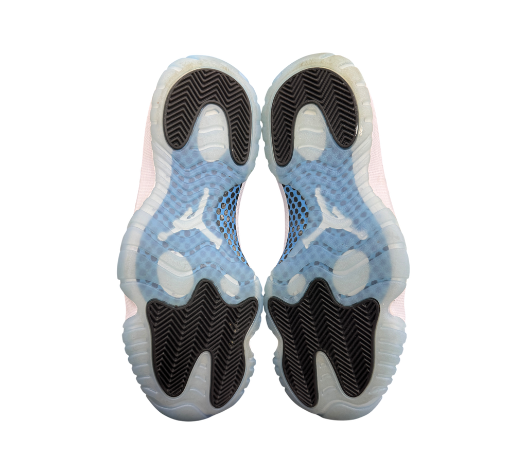 Genesis Boutique Jordan 11 Legend Blue sneakers showing the translucent icy blue and black herringbone rubber outsoles