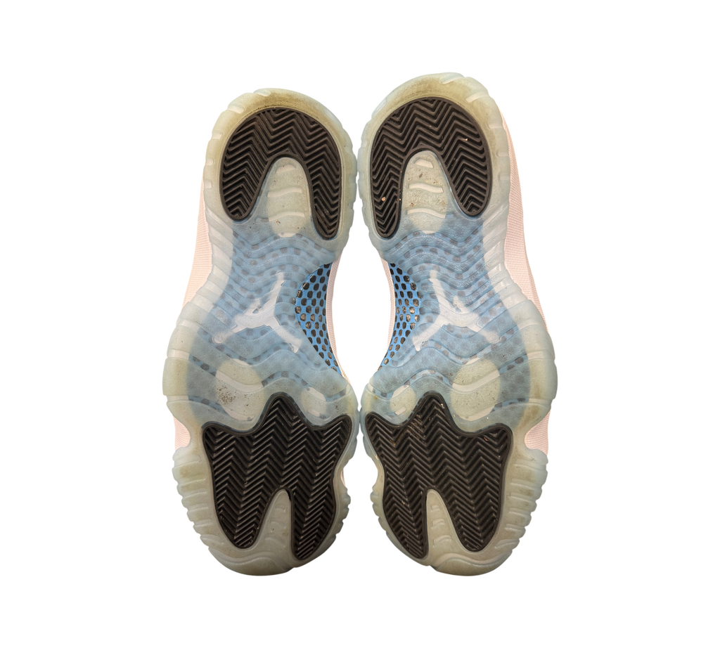 Genesis Boutique used Jordan 11 Legend Blue sneakers showing the translucent icy blue and black rubber outsoles