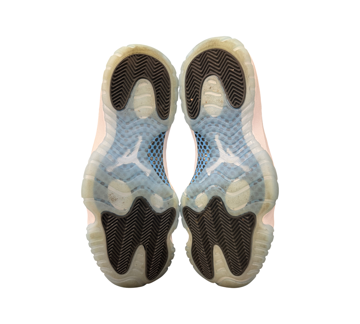 Genesis Boutique used Jordan 11 Legend Blue sneakers showing the translucent icy blue and black rubber outsoles