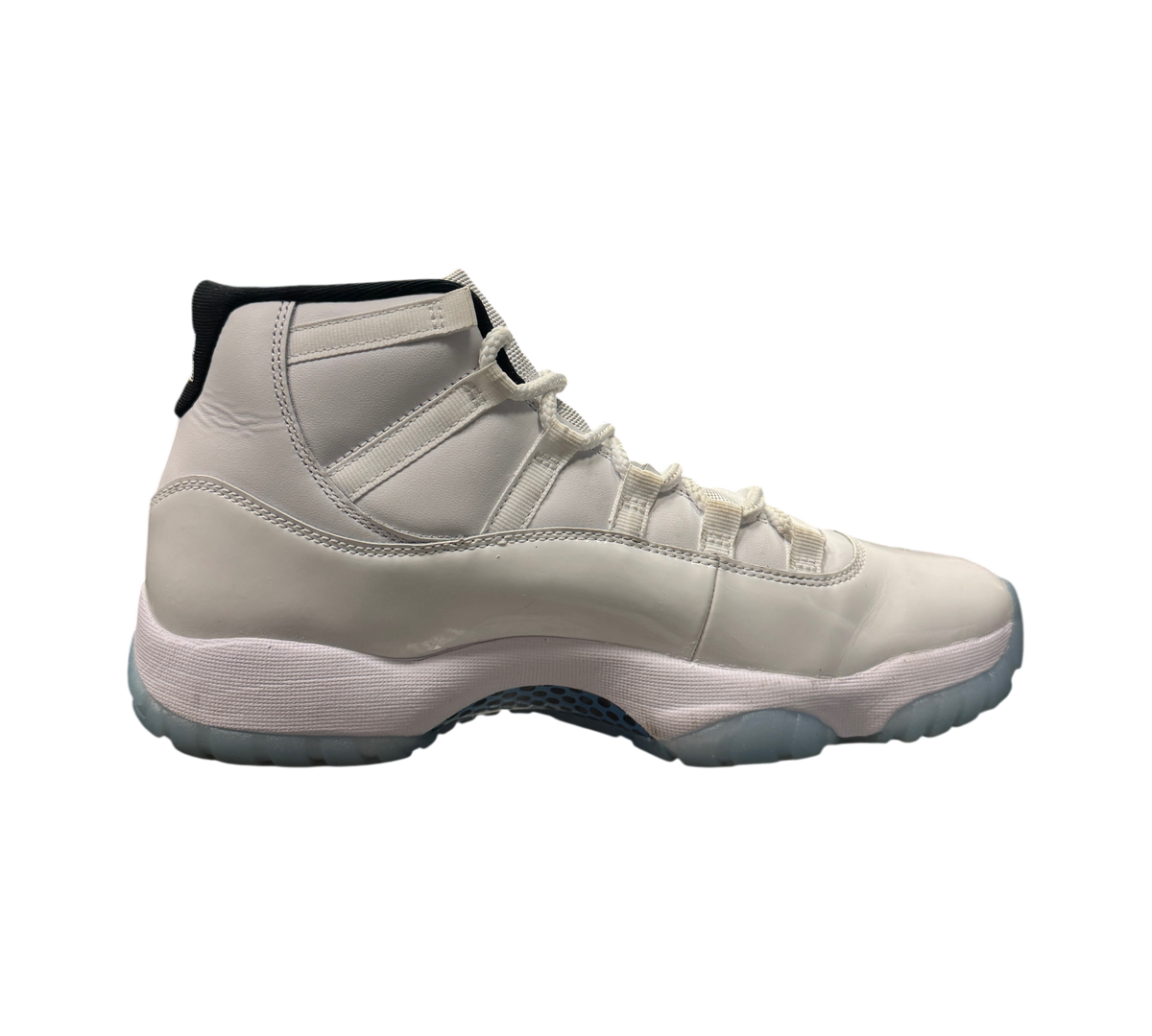 Genesis Boutique Jordan 11 Legend Blue sneakers in white leather with icy blue translucent soles on display
