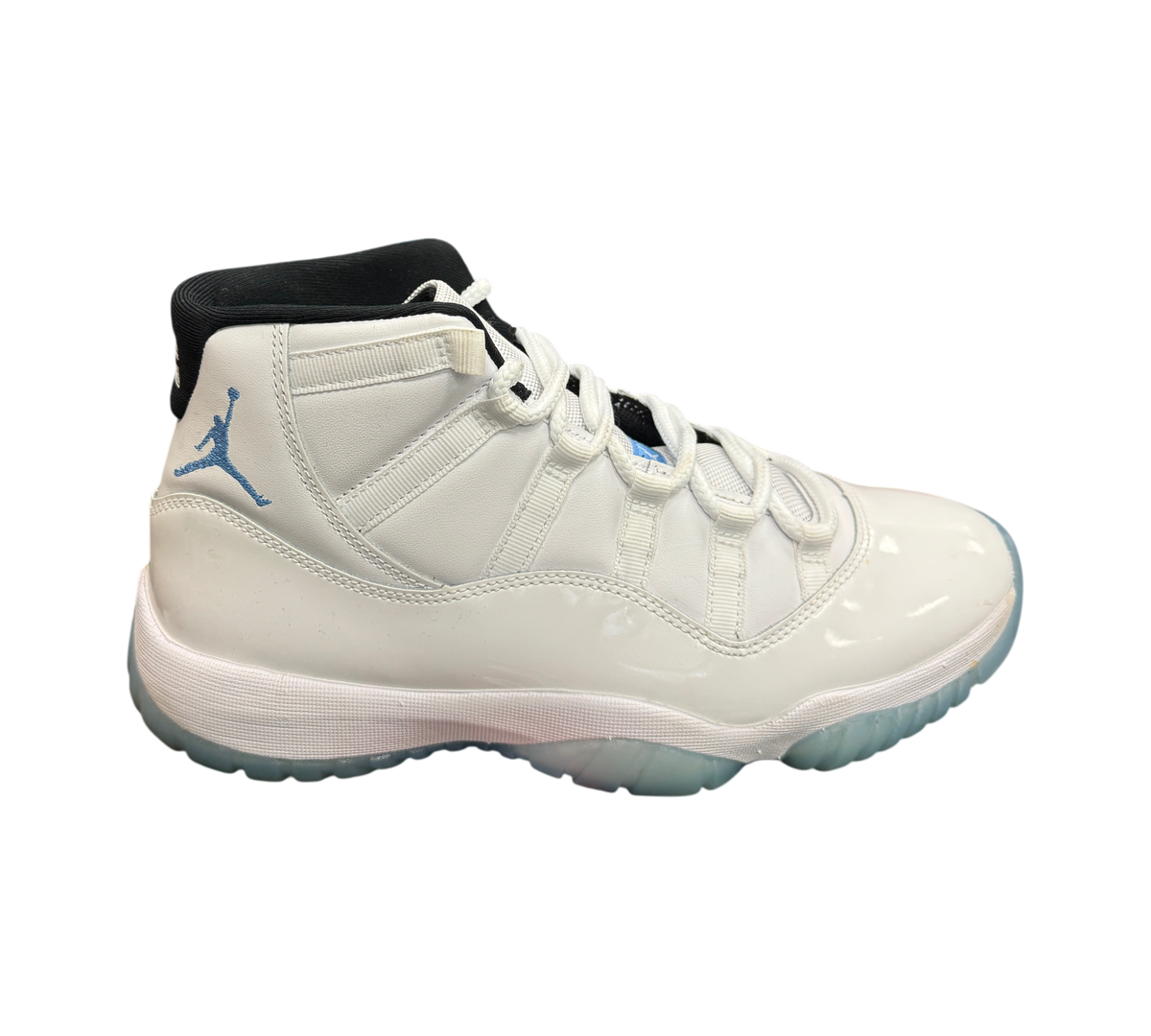 Genesis Boutique Jordan 11 Legend Blue sneakers in white patent leather with light blue Jumpman logo