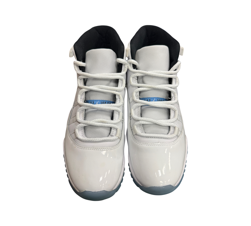 Genesis Boutique Jordan 11 Legend Blue sneakers in white patent leather with light blue accents and white laces