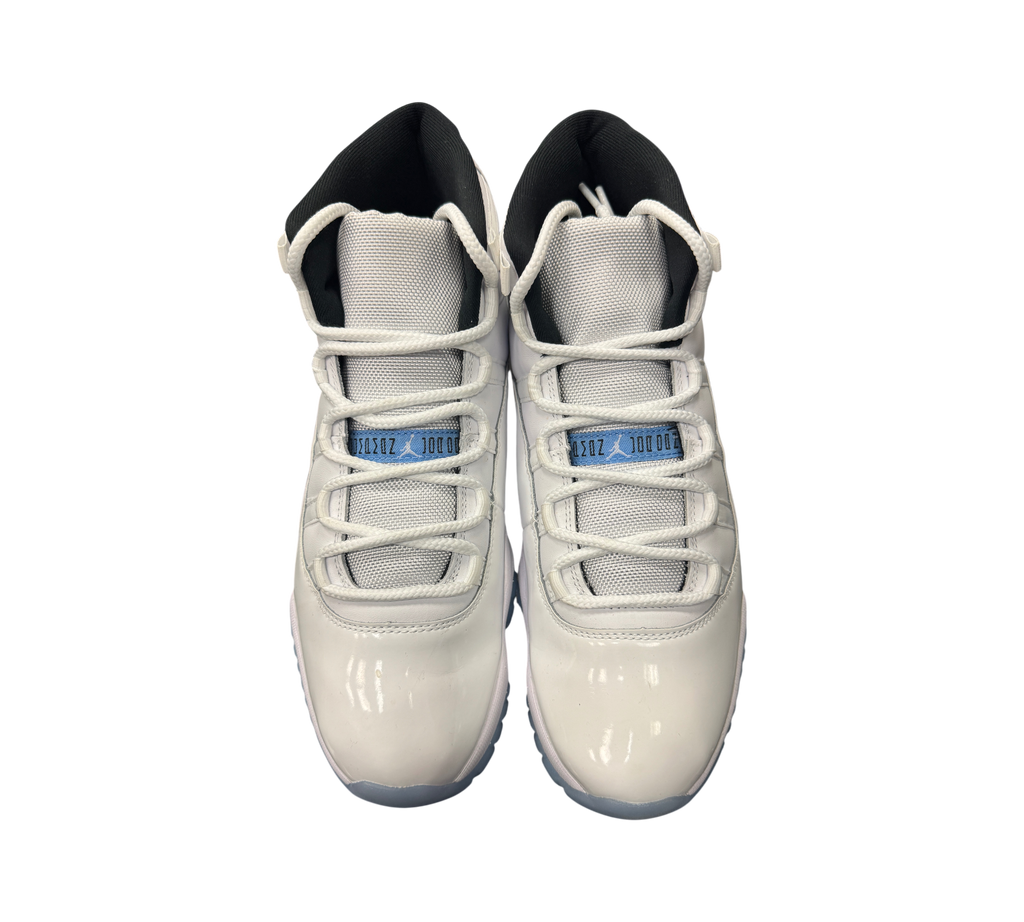 Genesis Boutique Jordan 11 Legend Blue sneakers featuring white patent leather, mesh upper, and light blue accents.