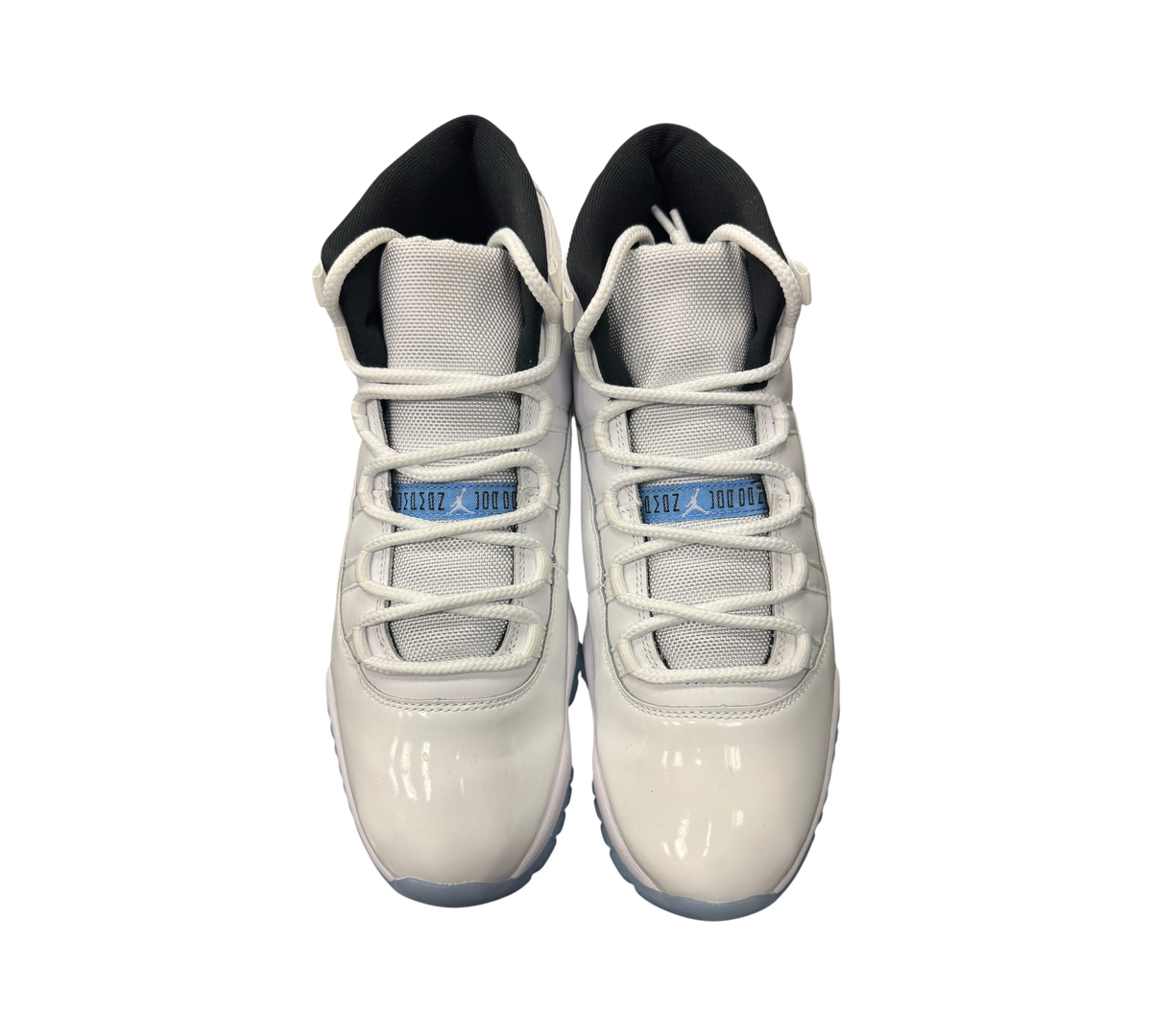 Genesis Boutique Jordan 11 Legend Blue sneakers featuring white patent leather, mesh upper, and light blue accents.