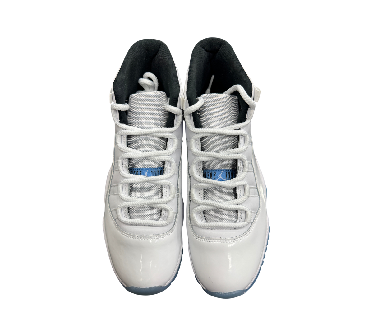 Genesis Boutique Jordan 11 Legend Blue sneakers in white patent leather with light blue accents and black lining