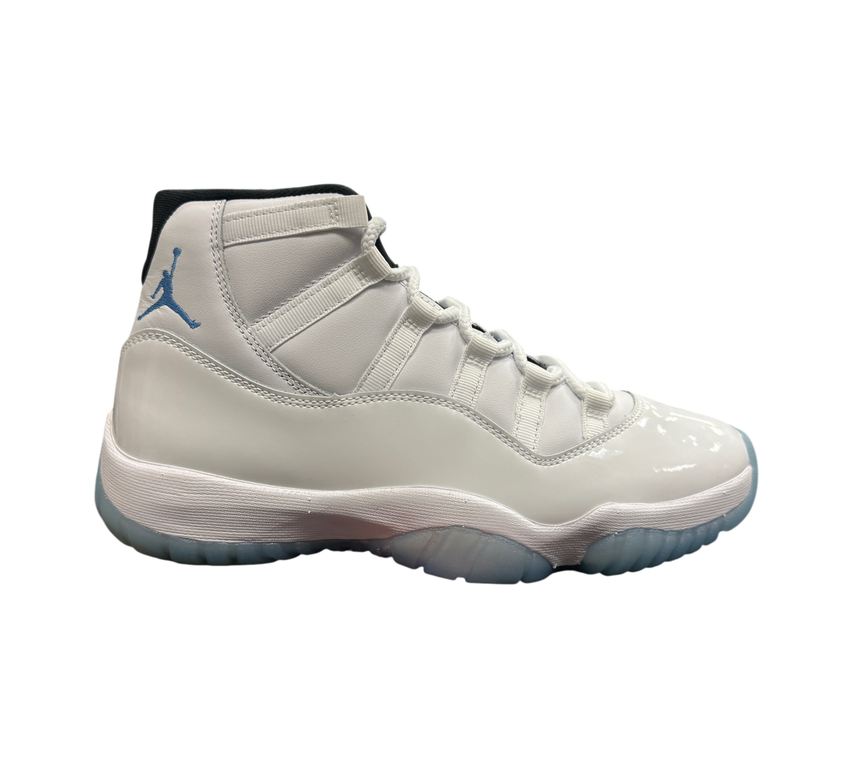 Genesis Boutique Jordan 11 Legend Blue sneakers in white patent leather with light blue Jumpman logo on a shoe box