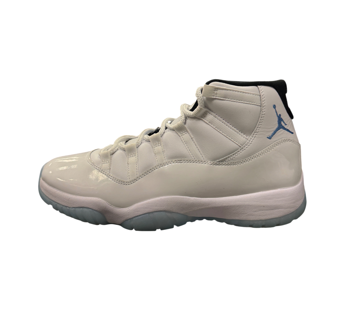 Genesis Boutique Jordan 11 Legend Blue sneaker in white patent leather with light blue Jumpman logo on display