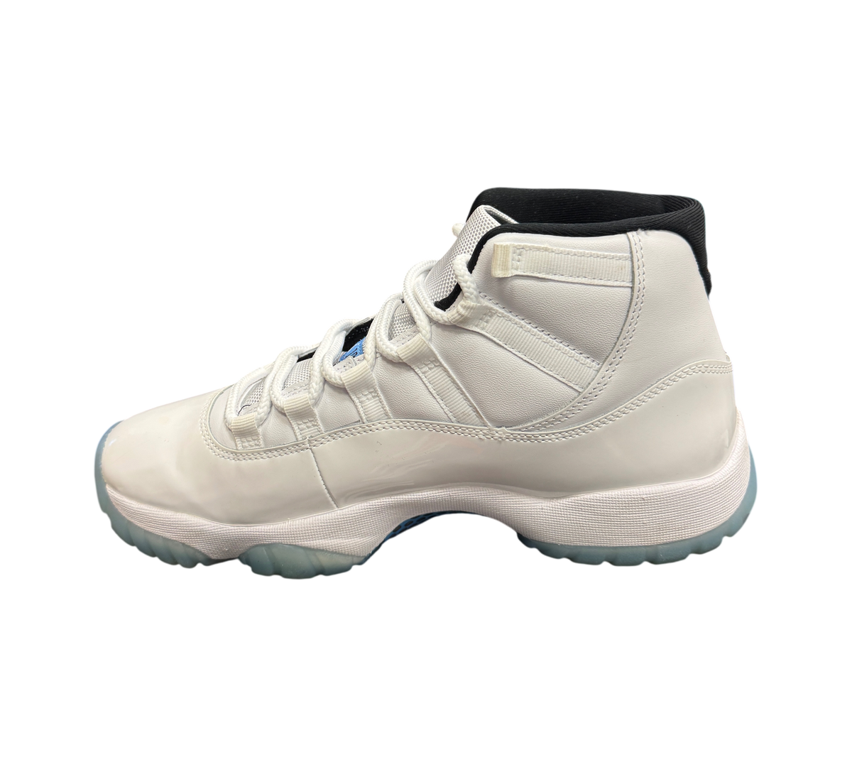 Genesis Boutique Jordan 11 Legend Blue sneakers in white leather with black accents and icy blue translucent outsole.