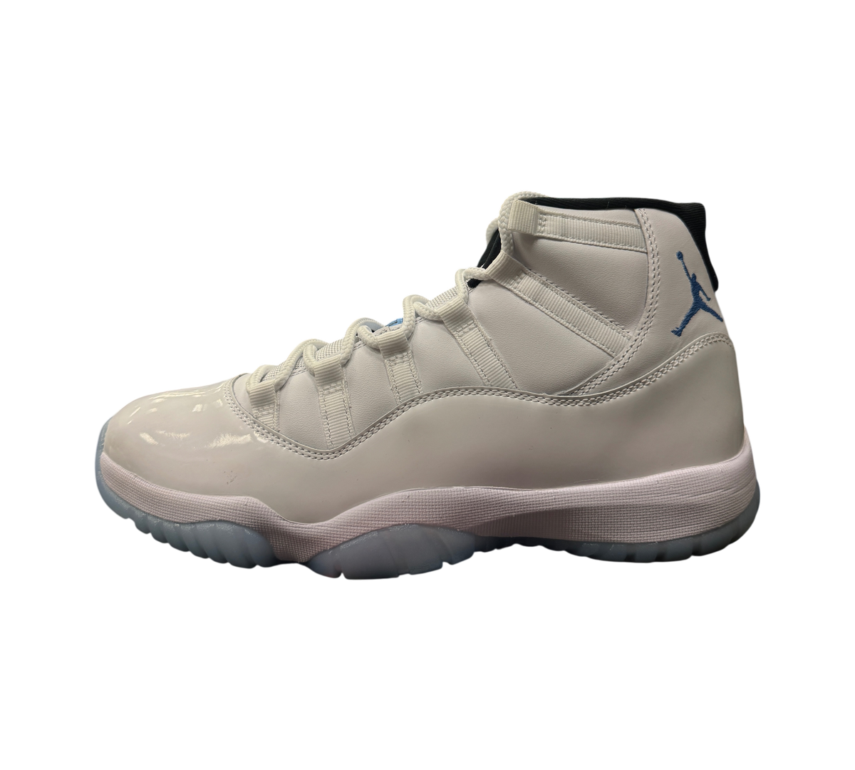 Genesis Boutique Jordan 11 Legend Blue sneaker in white patent leather with light blue Jumpman logo and icy blue sole