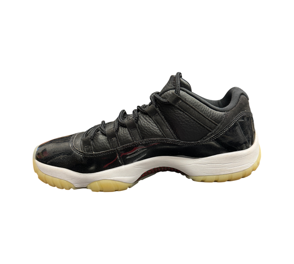 Genesis Boutique Jordan 11 Low 72-10 sneakers in black leather and patent leather with a white midsole and gum sole
