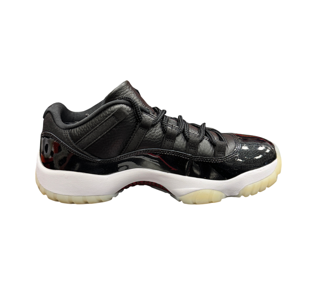 Genesis Boutique Jordan 11 Low 72-10 sneakers in black leather and patent leather with white midsole and milky outsole