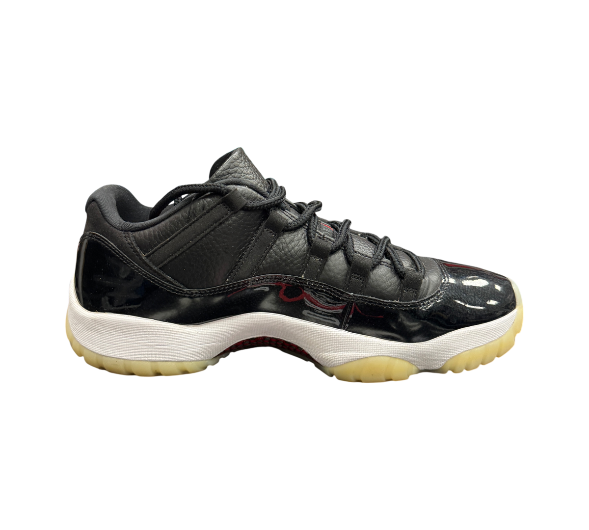Genesis Boutique Jordan 11 Low 72-10 sneakers in black leather and patent leather with a white midsole and gum outsole