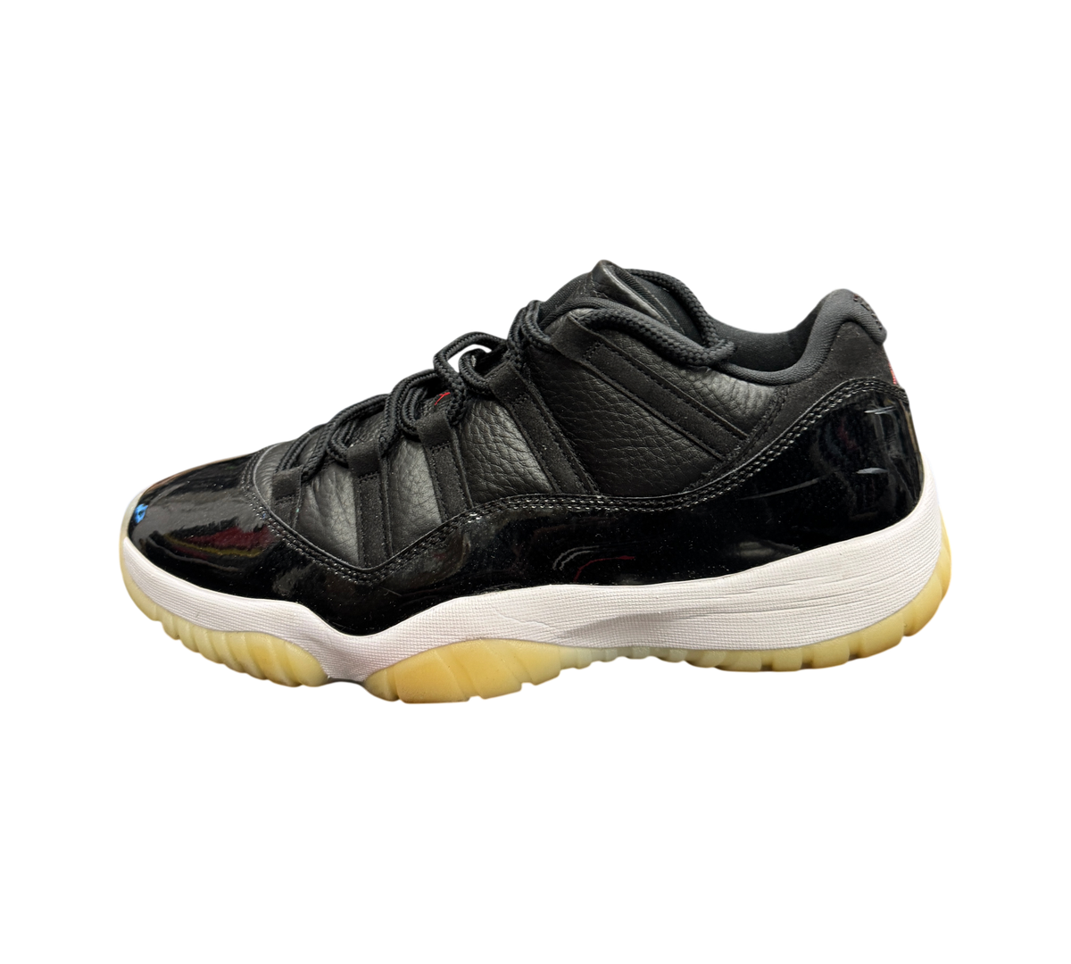 Genesis Boutique Jordan 11 Low 72-10 sneakers in black leather and patent leather with a white midsole and gum sole.