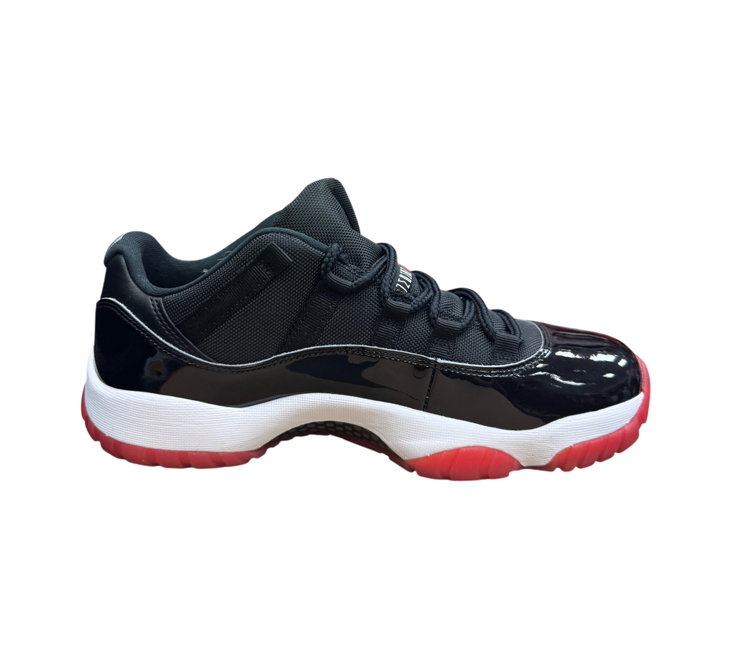 Genesis Boutique pre-owned Jordan 11 Low Bred sneakers featuring black mesh, patent leather, and a red translucent sole