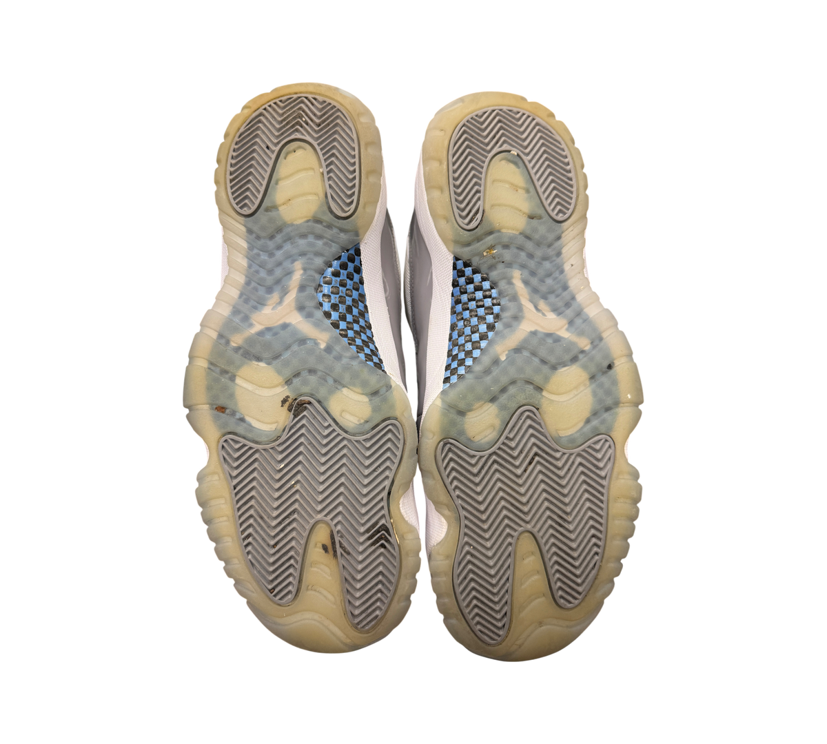 Genesis Boutique used Jordan 11 Low Cement Grey sneakers showing the translucent outsoles and carbon fiber plates.