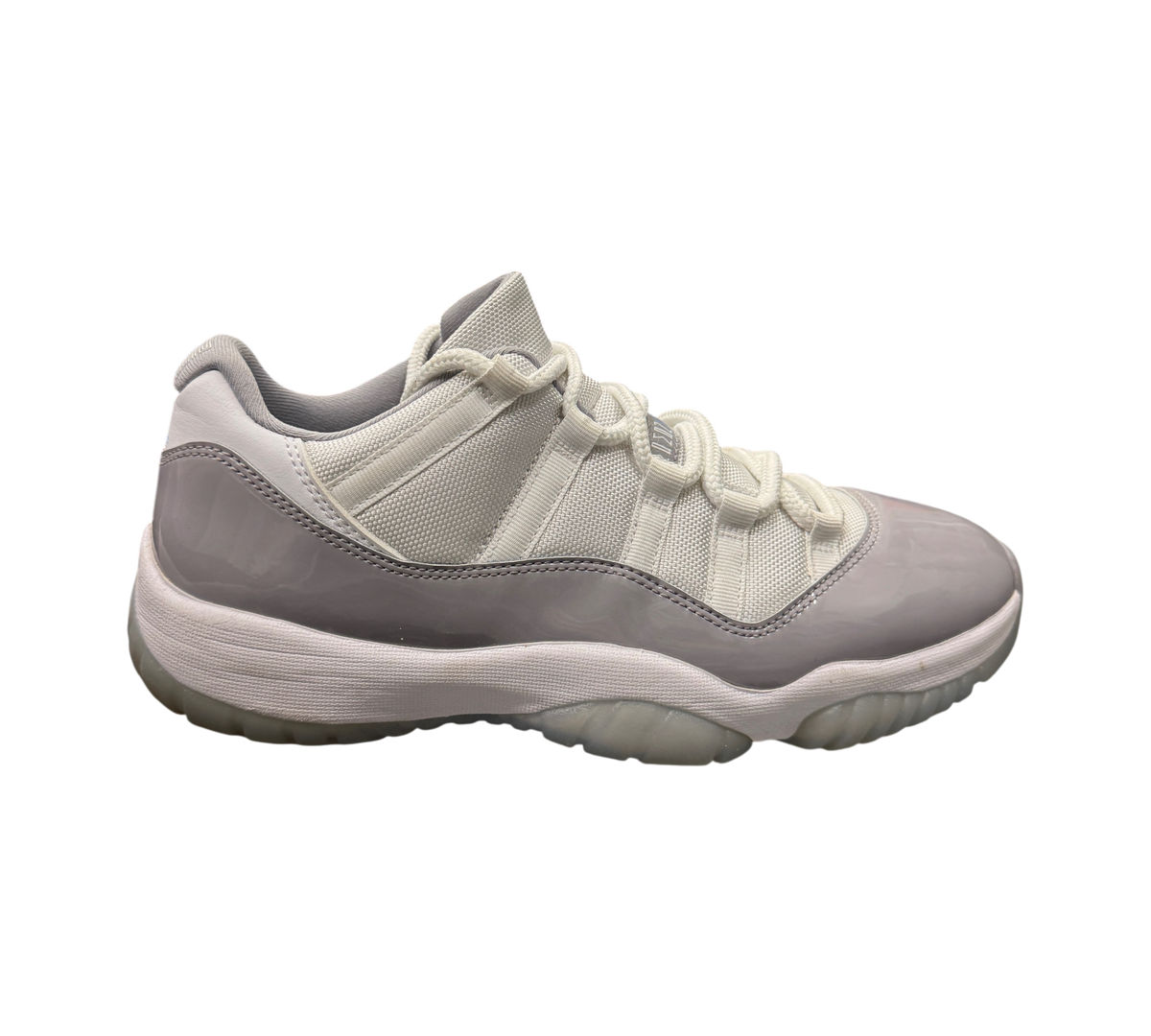 Genesis Boutique pre-owned Jordan 11 Low Cement Grey sneakers featuring white mesh and grey patent leather overlays.