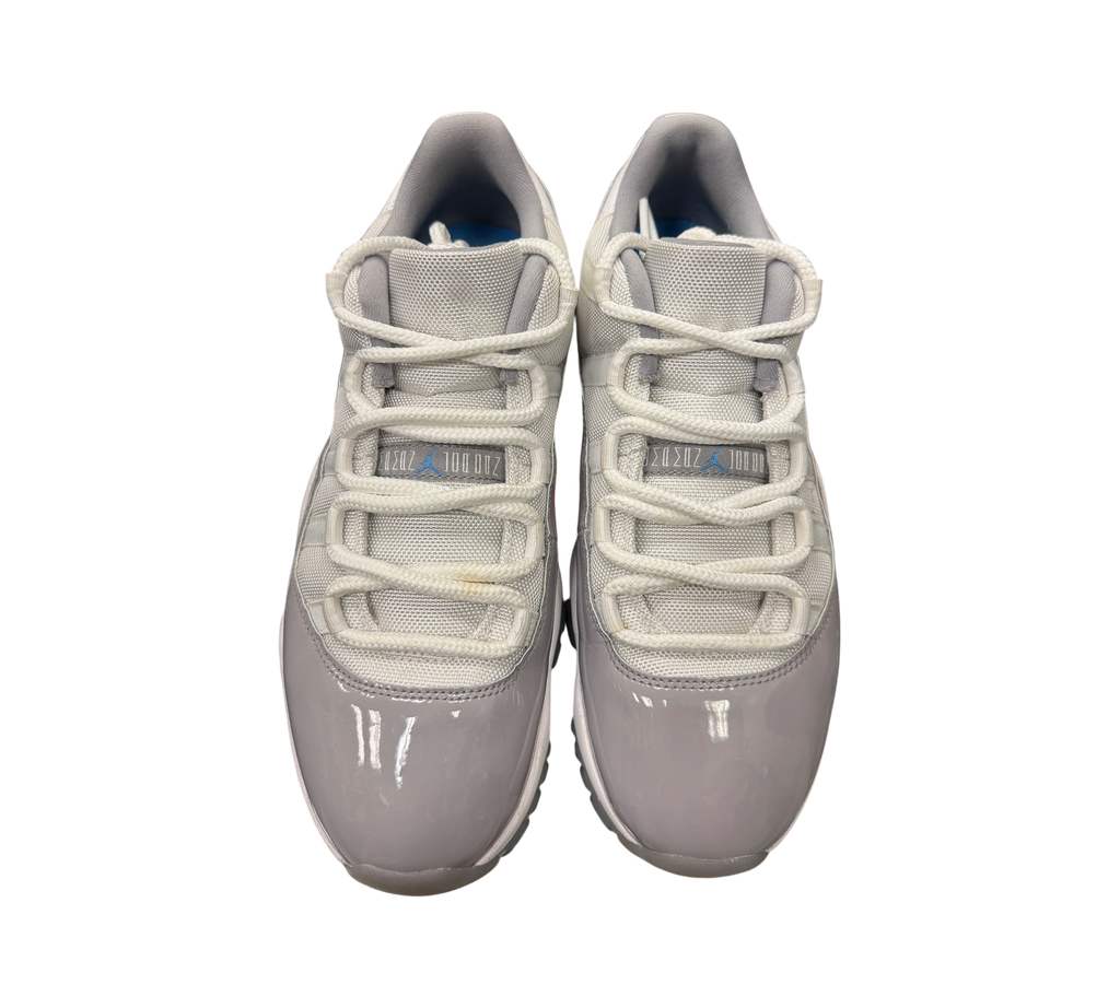 Genesis Boutique pre-owned Jordan 11 Low Cement Grey sneakers with white mesh uppers and grey patent leather mudguards.