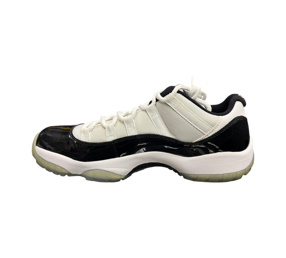 Genesis Boutique pre-owned Jordan 11 Low Concord sneakers featuring white mesh, black patent leather, and icy outsole.