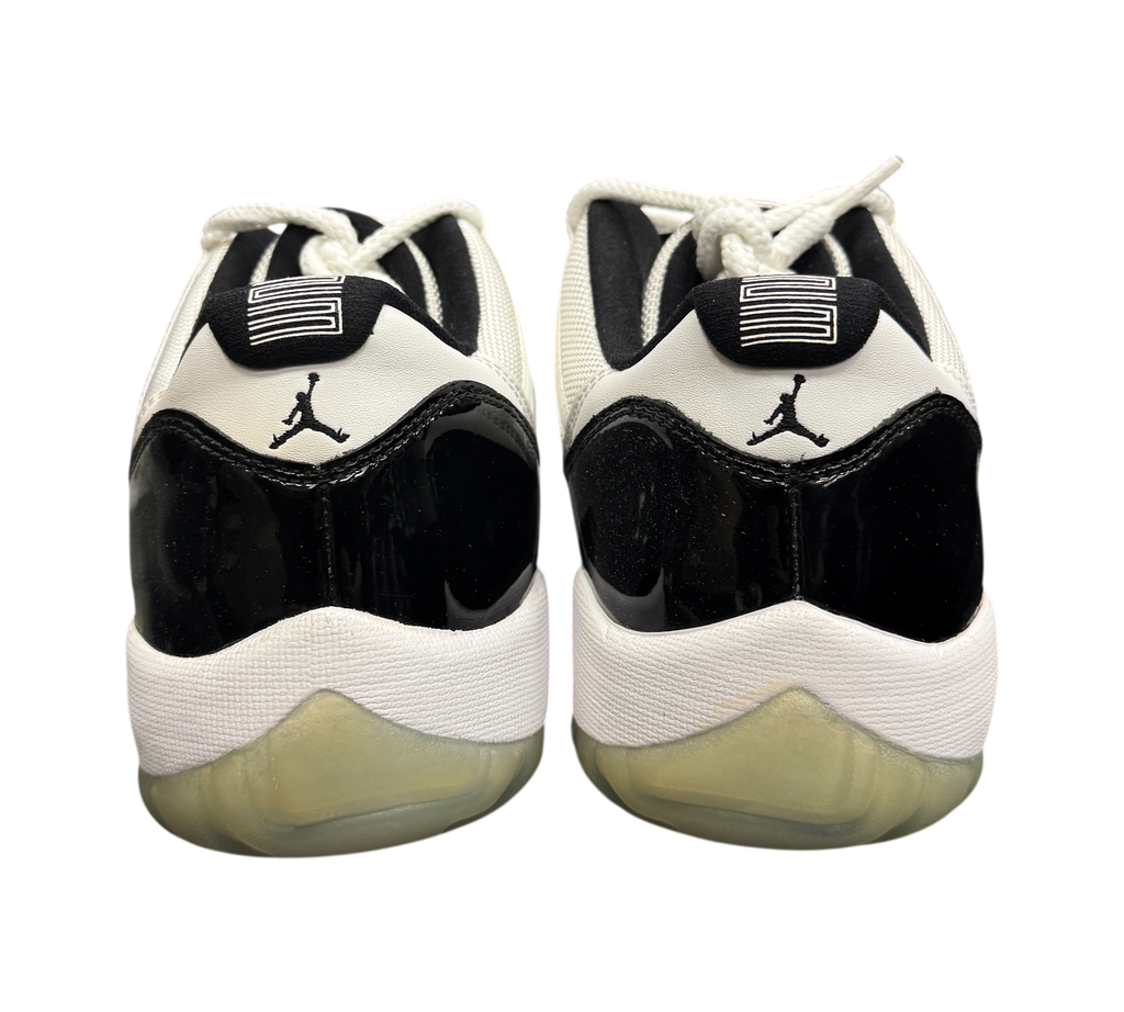 Genesis Boutique pre-owned Jordan 11 Low Concord sneakers featuring black patent leather and white mesh details.