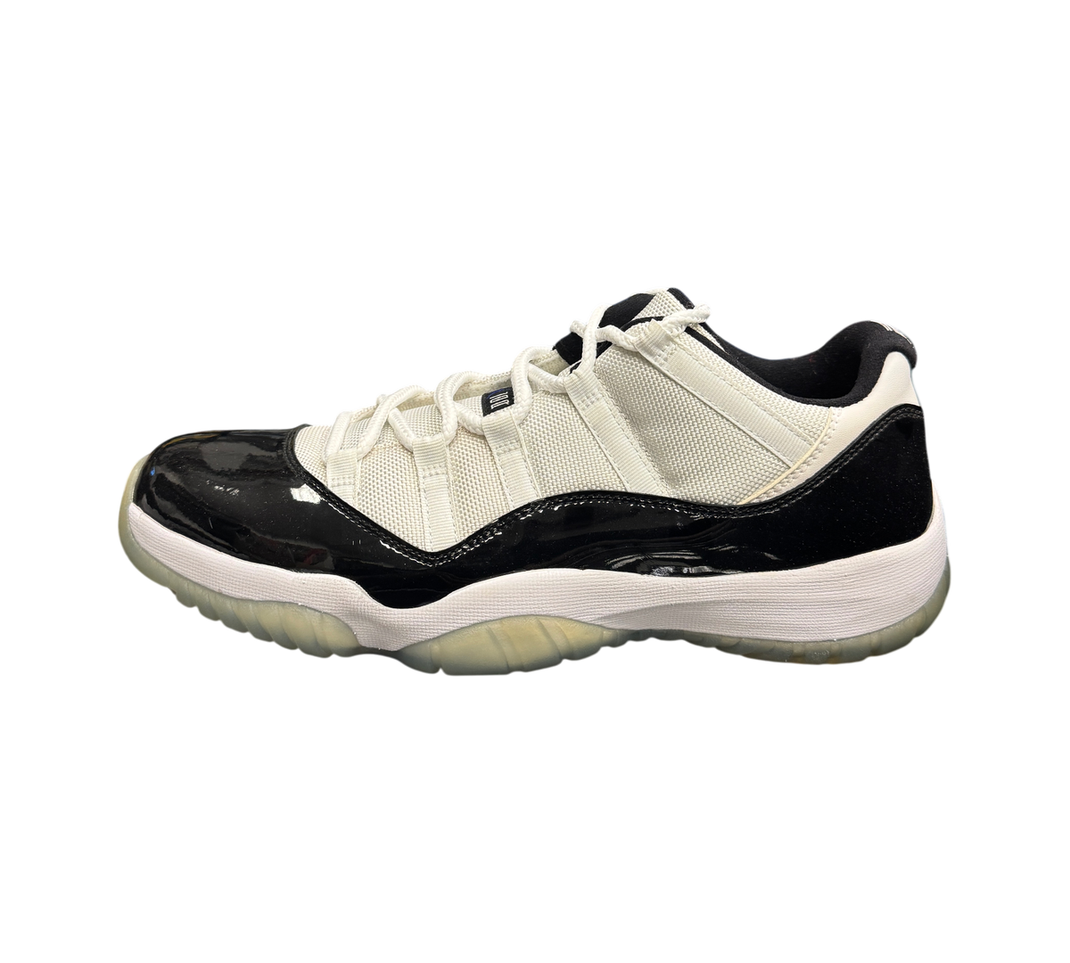 Genesis Boutique pre-owned Jordan 11 Low Concord sneakers featuring white mesh upper, black patent leather, and icy sole.