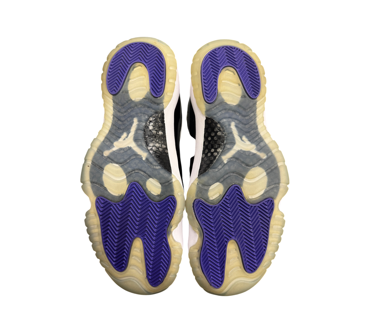 Genesis Boutique used Jordan 11 Low Concord sneakers showing purple and translucent outsoles with carbon fiber plates