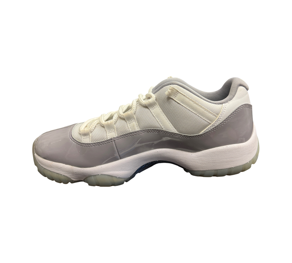Genesis Boutique Jordan 11 Low Grey Cement sneakers featuring white mesh, grey patent leather, and translucent soles.