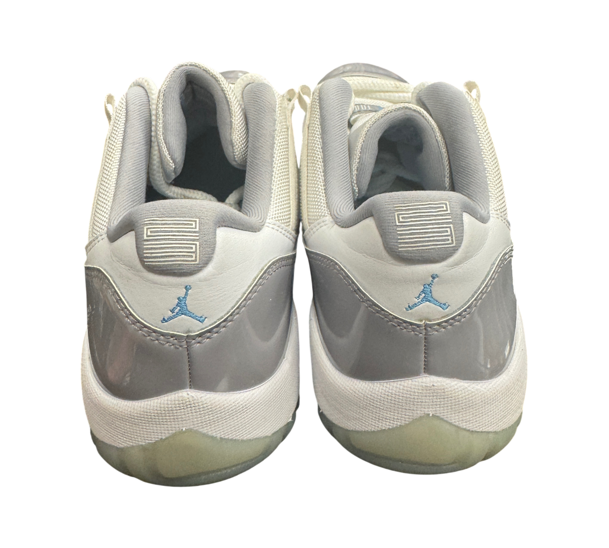 Genesis Boutique pre-owned Jordan 11 Low Grey Cement sneakers featuring grey patent leather and light blue Jumpman logo