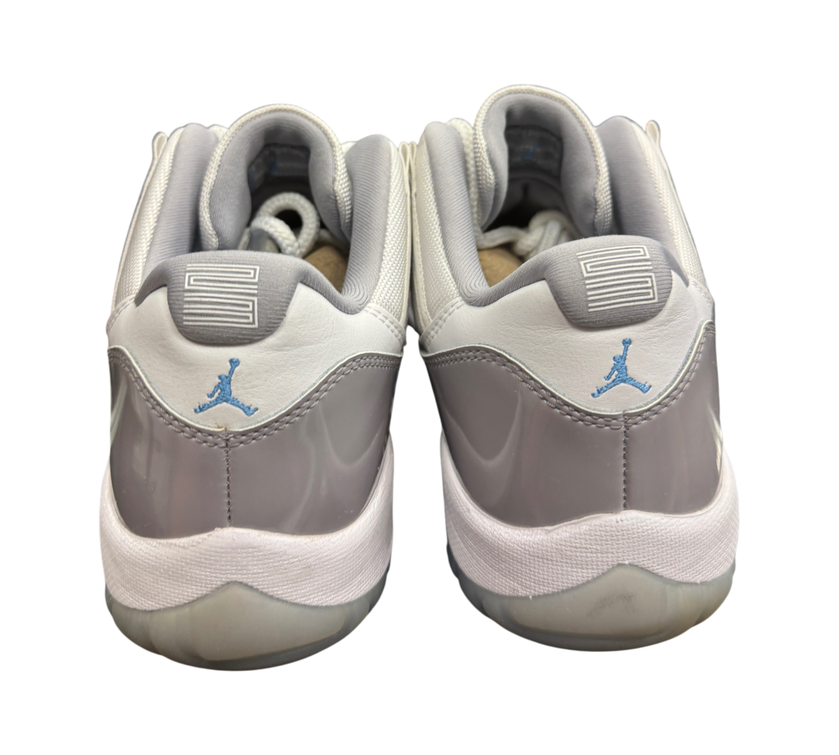 Genesis Boutique Jordan 11 Low Grey Cement sneakers featuring patent leather heels and blue Jumpman logos.
