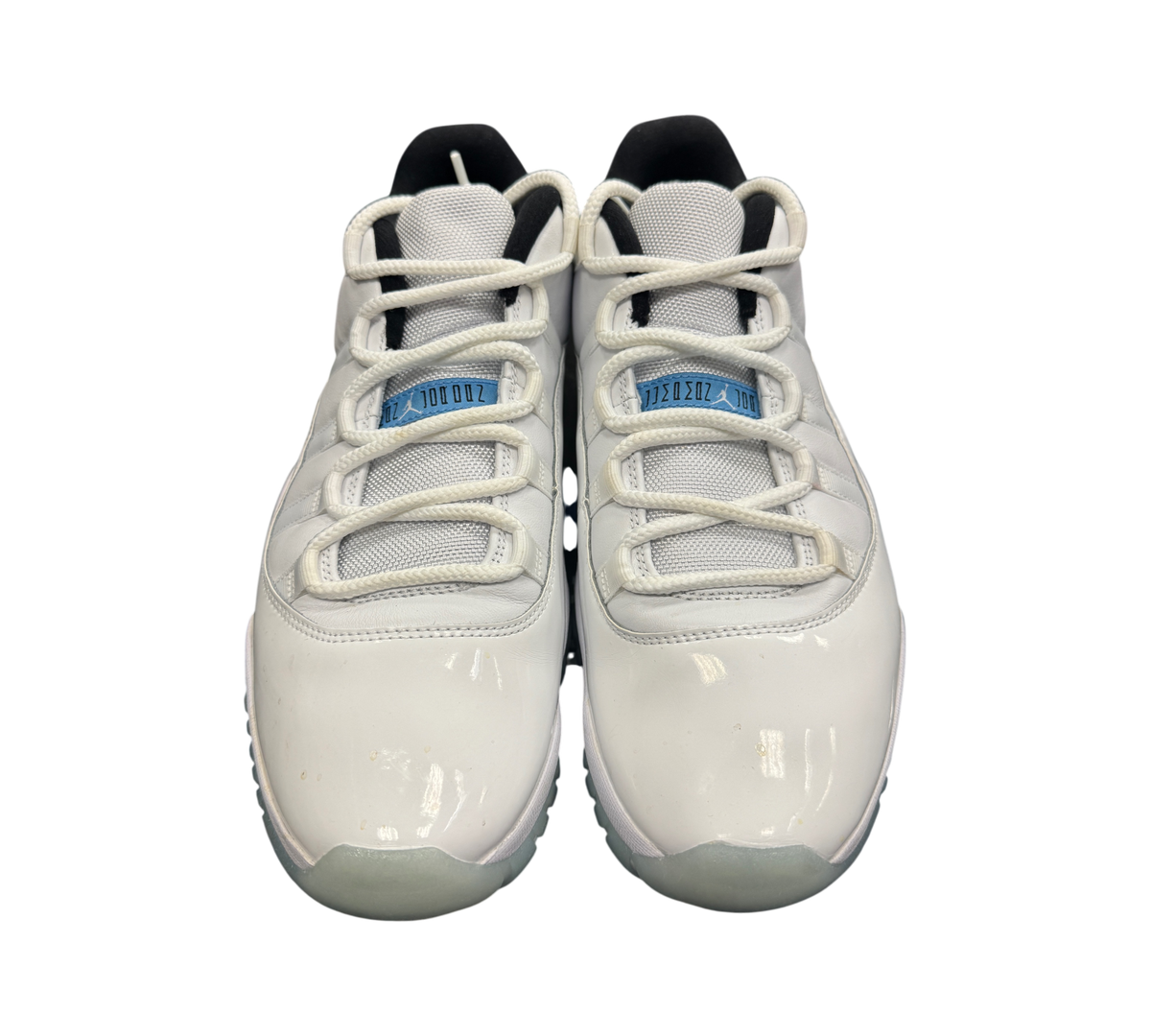 Genesis Boutique Jordan 11 Low Legend Blue sneakers in white patent leather with light blue accents and white laces