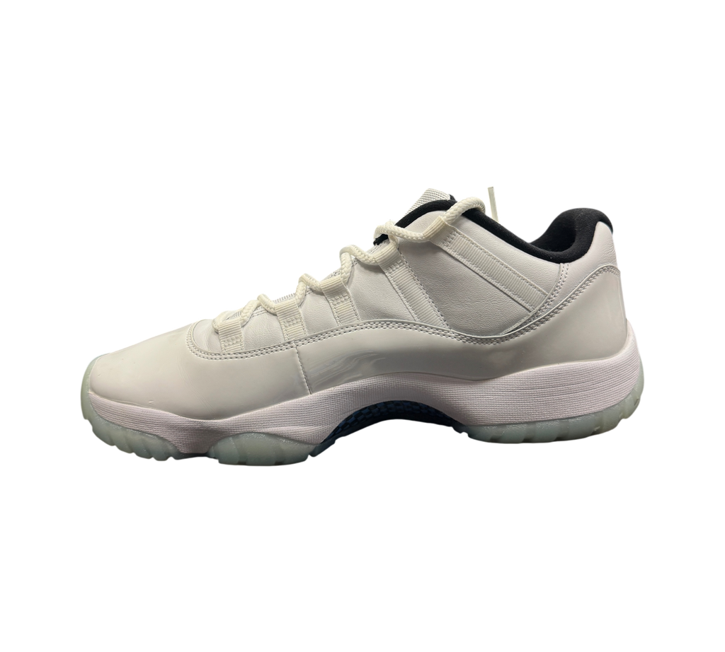 Genesis Boutique Jordan 11 Low Legend Blue sneaker in white patent leather with light blue accents on a display box