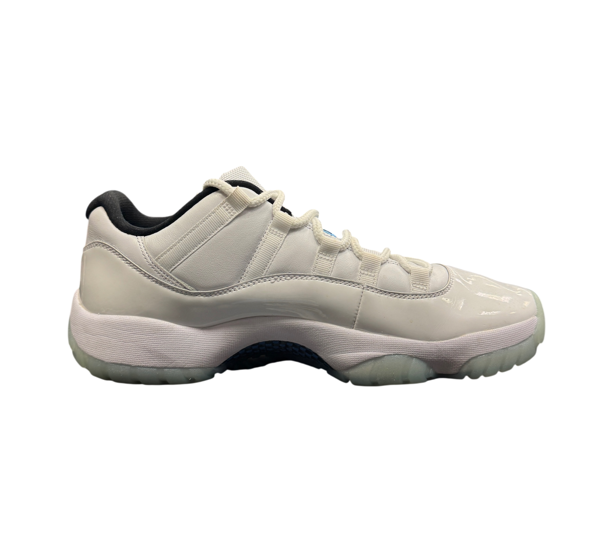 Genesis Boutique Jordan 11 Low Legend Blue sneakers in white patent leather with light blue accents on a shoe box