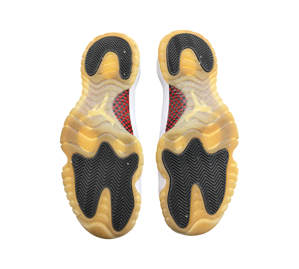 Genesis Boutique Jordan 11 Low 72-10 sneakers showing the black and gum rubber herringbone traction outsoles.