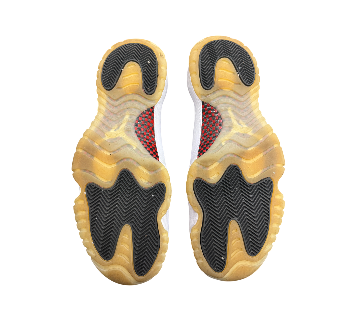 Genesis Boutique Jordan 11 Low 72-10 sneakers showing the black and gum rubber herringbone traction outsoles.