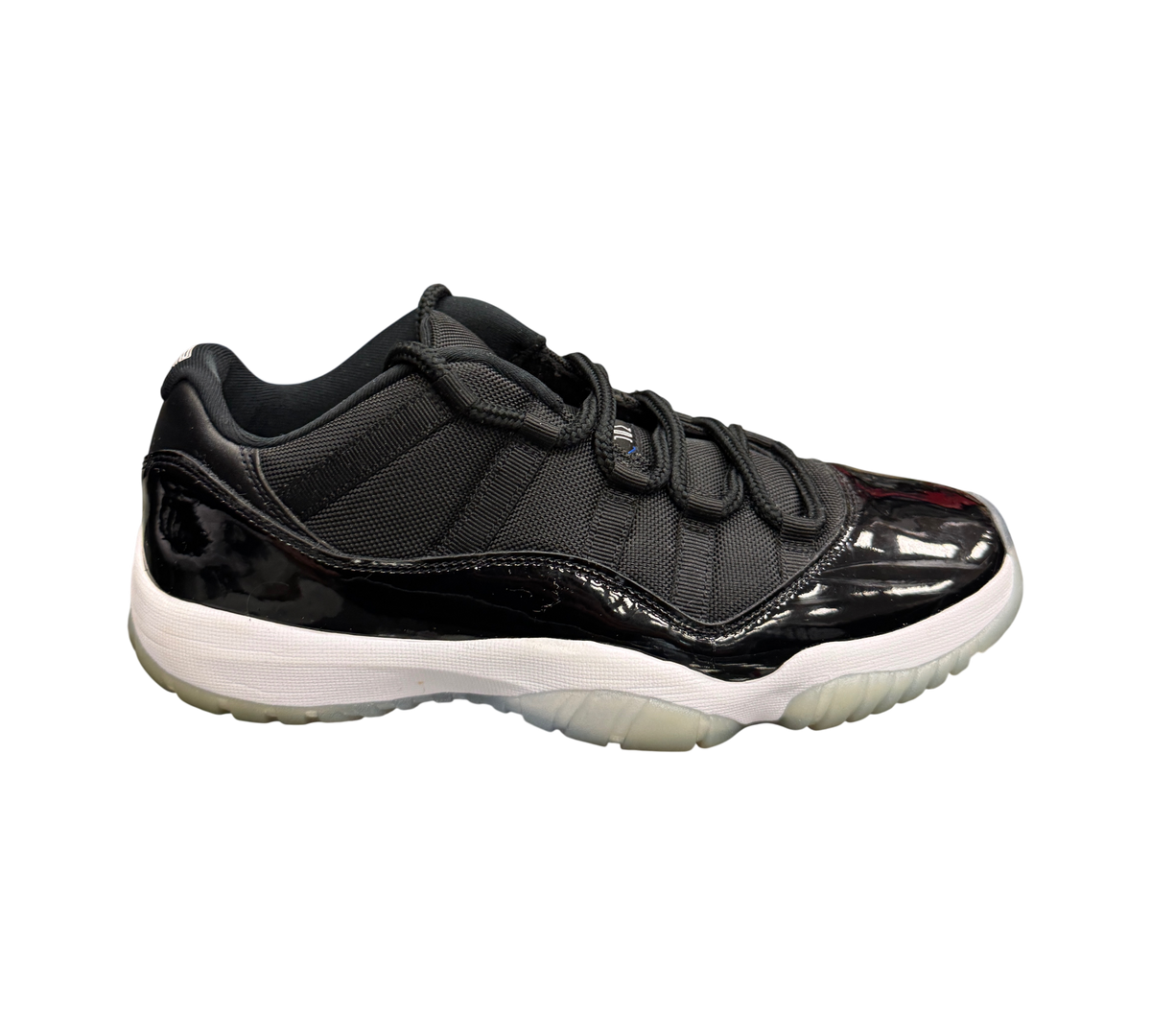 Genesis Boutique Jordan 11 Low Space Jam sneakers in black mesh and patent leather with a white midsole and icy sole.
