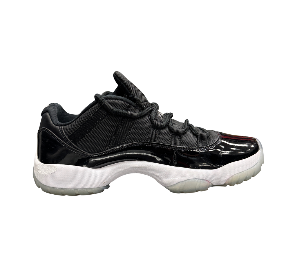 Genesis Boutique Jordan 11 Low Space Jam sneakers in black with patent leather mudguard and translucent outsole.