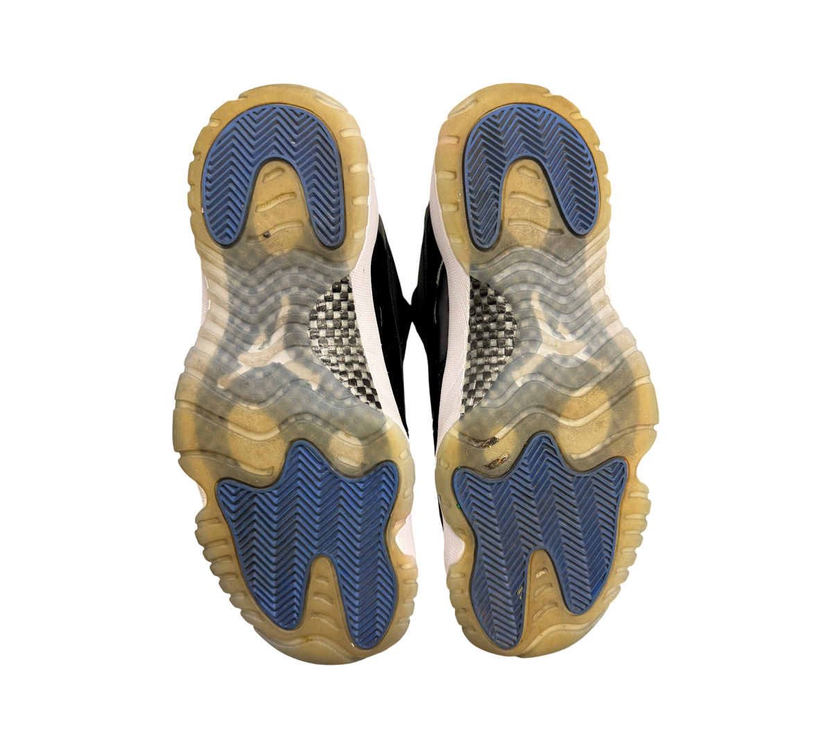 Genesis Boutique Jordan 11 Low Space Jam sneakers showing the blue and translucent rubber outsoles with carbon fiber