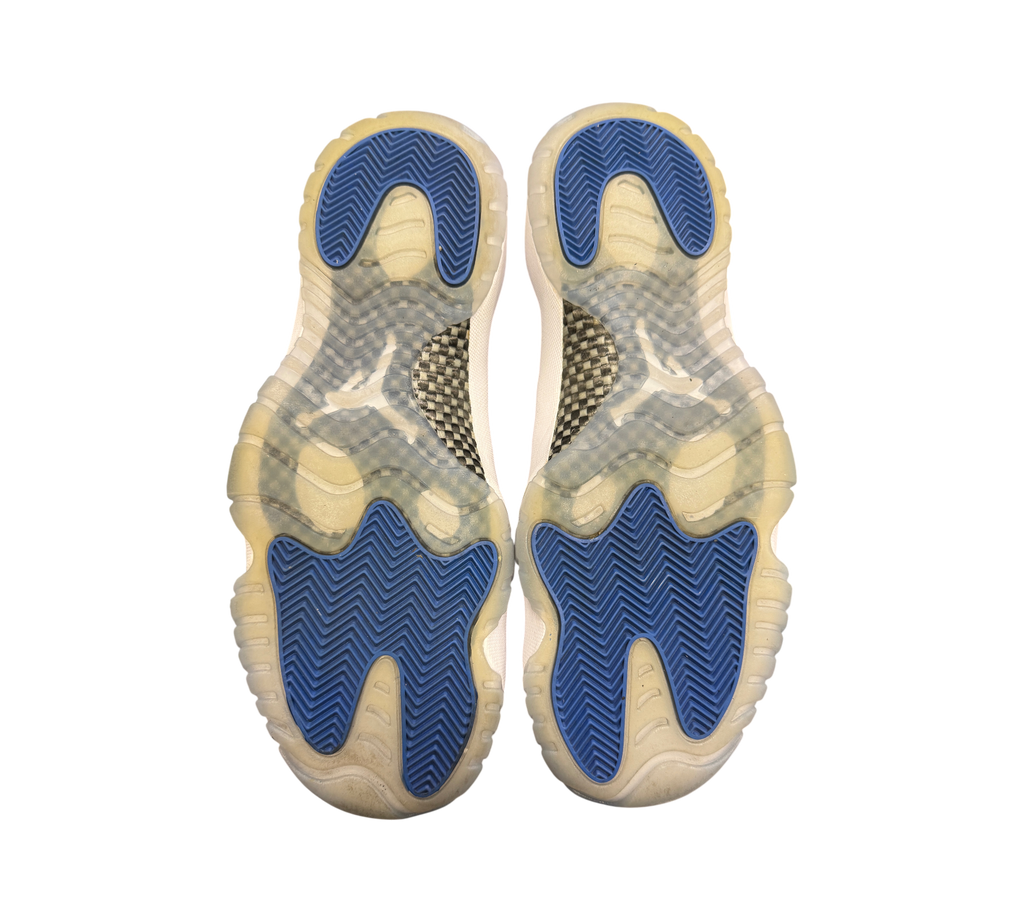 Genesis Boutique used Jordan 11 Low Space Jam sneakers showing blue and translucent rubber outsoles with carbon fiber