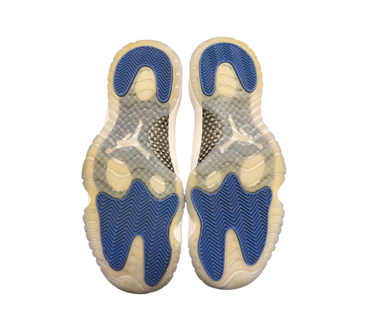Genesis Boutique used Jordan 11 Low Space Jam sneakers showing blue and translucent rubber outsoles with carbon fiber
