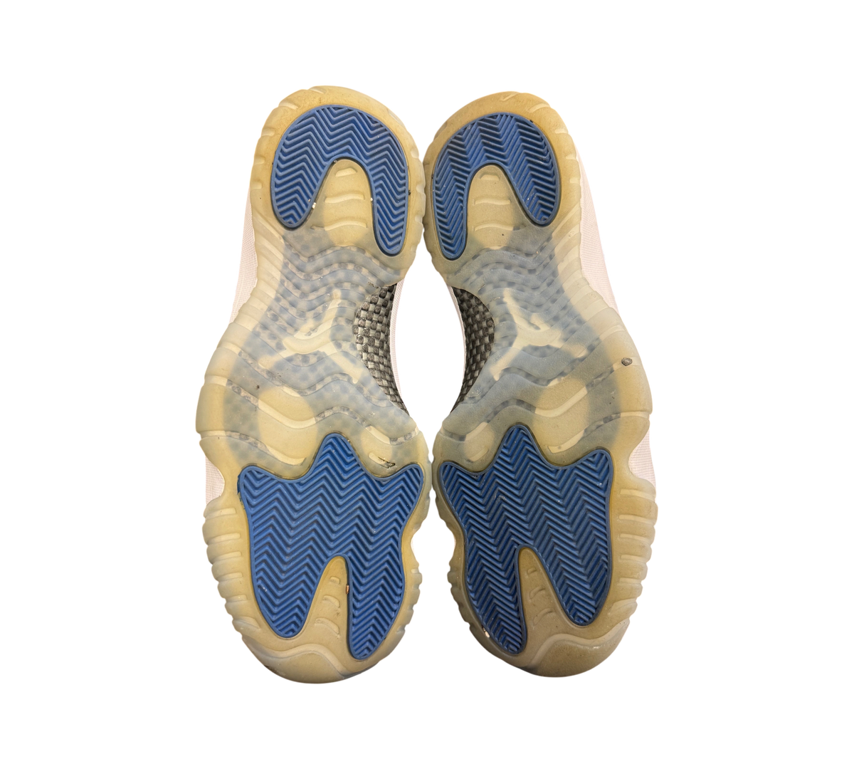 Genesis Boutique Jordan 11 Low Space Jam sneakers showing the blue and translucent rubber outsoles from below