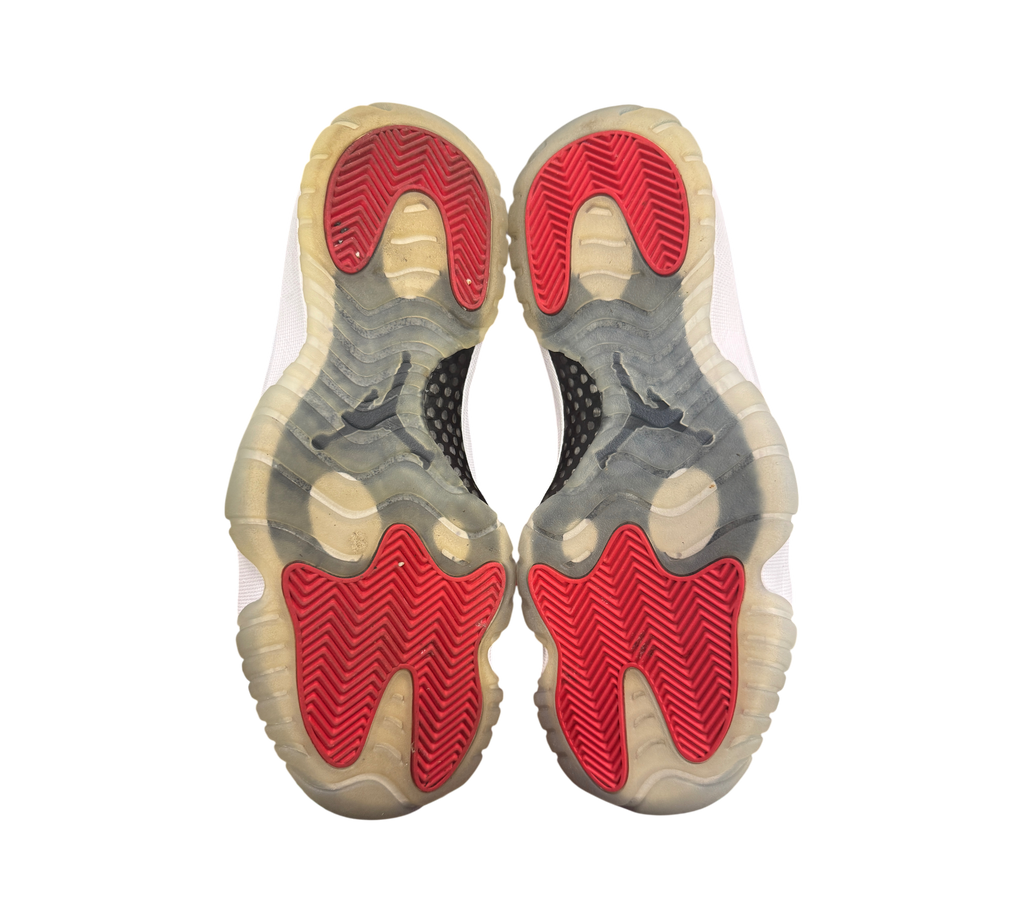 Genesis Boutique Jordan 11 Win Like 96 sneakers showing red and translucent rubber outsoles with herringbone traction