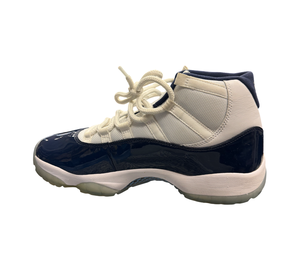 Genesis Boutique Jordan 11 "Win Like 82" sneakers in white and navy patent leather with translucent soles.