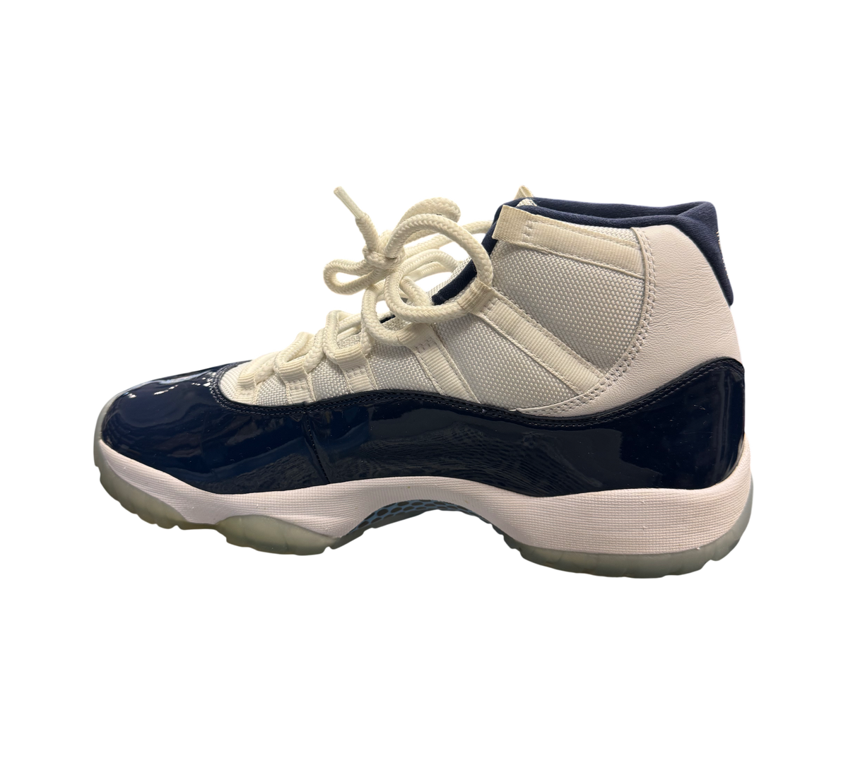 Genesis Boutique Jordan 11 "Win Like 82" sneakers in white and navy patent leather with translucent soles.
