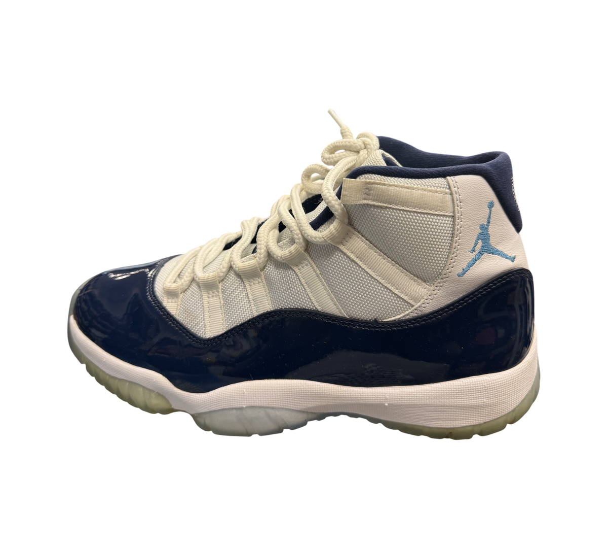 Genesis Boutique Jordan 11 "Win Like 82" sneakers with navy patent leather and white mesh.