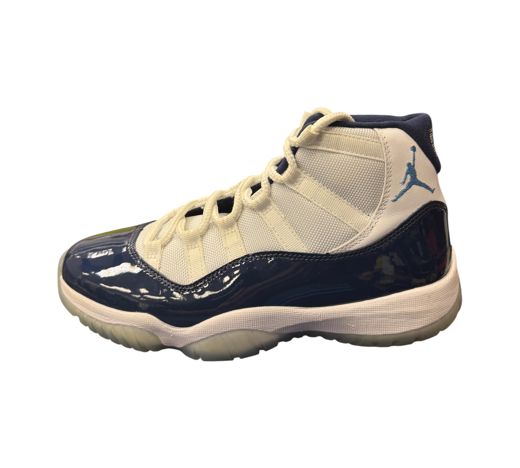 Genesis Boutique Jordan 11 Win Like 82 sneakers featuring white mesh, navy patent leather, and light blue Jumpman logo.