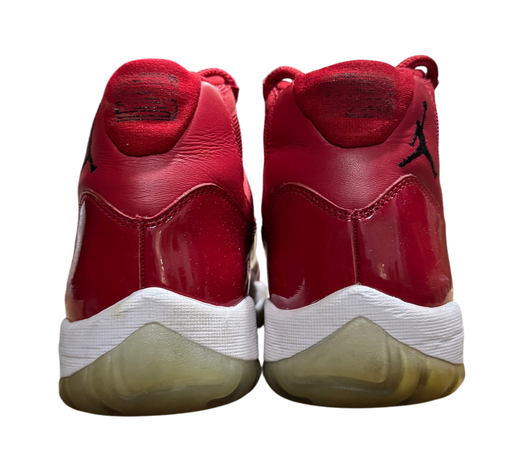 Genesis Boutique Jordan 11 Win Like 96 sneakers in red patent leather, back view showing heel branding and soles.